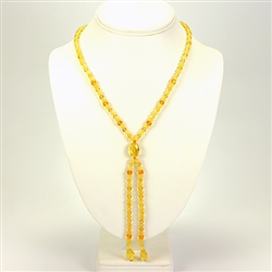 Composed of alternating citrine and custard color round amber beads ending with a large citrine amber oval bead attaching 2 additional 4" strands. Very elegant.