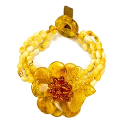 Bozena Przytocka is a designer of artistic amber jewelry based in Gdansk, Poland. Here is a beautiful example of her ability to blend different shades and shapes of amber to create a stunning bracelet. Center amber flower is 1.5" - 4cm in diameter.  4 st