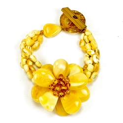 Bozena Przytocka is a designer of artistic amber jewelry based in Gdansk, Poland. Here is a beautiful example of her ability to blend different shades and shapes of amber to create a stunning bracelet. Center amber flower is 1.5" - 4cm in diameter. 4