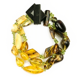 Bozena Przytocka is a designer of artistic amber jewelry based in Gdansk, Poland. Here is a beautiful example of her ability to blend a variety of amber shapes and peridot to create a stunning bracelet.
