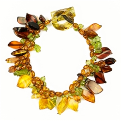 Bozena Przytocka is a designer of artistic amber jewelry based in Gdansk, Poland. Here is a beautiful example of her ability to blend a variety of amber shapes and peridot to create a stunning single strand bracelet.  Please note that the amber is a lit