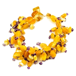 Amber and amethyst beaded strings woven together. Securely closes around your wrist with an amber toggle clasp. Amber is soft, only slightly harder than talc, and should be treated with care.