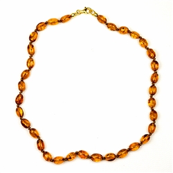 Lovely necklace composed of cognac colored amber. Gold colored cord w/ knot between each bead. Perfect size for children over three. Definitely not intended for children 3 or younger due to the small parts and choking hazard.