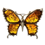 Beautiful hand made amber butterfly brooch with unique inclusions, set in sterling silver.  Size is approx 1" x 1.4".