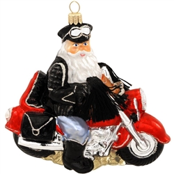 Boys need their toys, and even Santa can't resist test driving this delivery! Artfully crafted from glass in Poland and measuring 5¼" tall by 5¾" wide, this Biker Santa glass ornament is exquisitely detailed. Vibrant glazes and crisp glitter accents add a