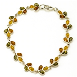Three colors of amber set in silver shaped to form a trail of leaves in this lovely bracelet 7" - 18cm long.