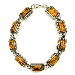 9 rectangular shaped amber beads each set in a sterling silver frame. 7" - 18cm long.