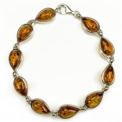 10  tear drop shaped amber beads each set in a sterling silver frame. 7" - 18cm long.