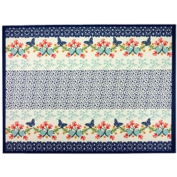 Large Polish cloth placemat featuring Polish stoneware colors and floral design. This material is 100% polyester.. Made in Poland.