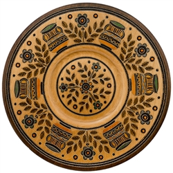 This Polish plate is made from beech wood in the mountain region of southern Poland called Podhale. The plates are cut and shaped on a lathe by hand. The floral designs are burned into the wood then painted after staining