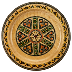 This Polish plate is made from beech wood in the mountain region of southern Poland called Podhale. The plates are cut and shaped on a lathe by hand. The designs are burned into the wood then painted after staining and varnishing. All the designs are