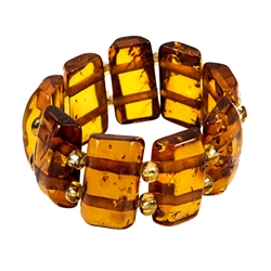 Delightful slices of natural amber connected  by a double strand of of woven stretch material and separated with beads. Rings start at size 5 and stretch to fit the largest fingers.