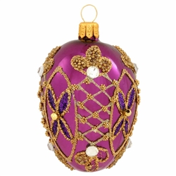 Impeccably detailed, this gorgeous purple egg ornament is intricately patterned with egg-squisite gold glitter designs. Masterfully hand-crafted of glass in Poland