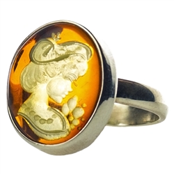 Unique and lovely honey amber cameo set in sterling silver.
The exquisitely detailed cameo design is hand-carved from the reverse side of the amber. Each cameo design varies slightly.