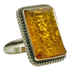 A perfectly cut rectangular piece of honey colored amber set in sterling silver.  Size approx 1" x .75"