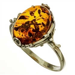 A nice size amber cabochon framed in a classic sterling silver frame.
