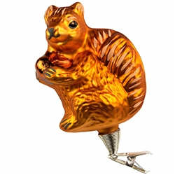Don't squirrel away this cute keepsake……display it for all to see! Hand-painted with shimmering glazes and sparkling gold accents, our 4" tall squirrel with acorn glass ornament comes ready to hang with a gold cord will add a natural touch to your tree!