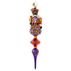 This royally dressed Nutcracker is on point and sure to impress with his rich purple, red and gold design. Chestnuts anyone?