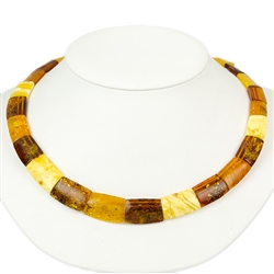 This stylish amber necklace features shades of yellow, honey, and cherry amber. The beads are slightly hexagonal in shape and slightly faceted.