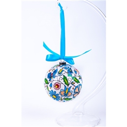 Folk art is the perfect souvenir from Poland. This ornament is inspired by the flower designs from the Kashub area of northwest Poland. Lightweight, unbreakable plastic with a decorative Kashub floral pattern. Comes with a green ribbon for handing. Size a