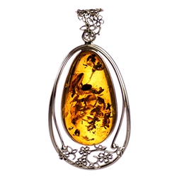 Sterling Silver with filigree detail surrounding a beautiful honey amber cabochon.