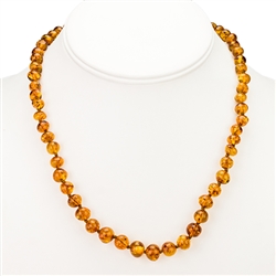 Golden honey amber beads, rounded and knotted between each bead. Gold vermeil clasp. Bead size varies from .25" to .37" wide.