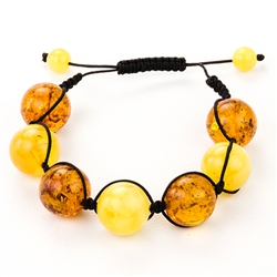This fine macrame bracelet is made with honey and  custard amber. This bracelet includes black cord and a slide clasp to fit most wrists