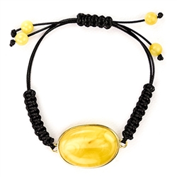 This fine macrame bracelet is made with custard colored amber. This bracelet includes black cord and a slide clasp to fit most wrists.
The amber cabachon is framed in gold vermeil and is approx 1.25" x .9".