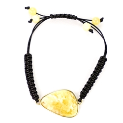 This fine macrame bracelet is made with custard colored amber. This bracelet includes black cord and a slide clasp to fit most wrists.
The amber cabachon is framed in gold vermeil and is approx 1.25" x 1".