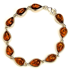 11 tear shaped amber beads each set in a sterling silver frame. 7" - 18cm long.