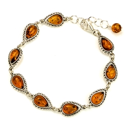 9 tear shaped amber beads each set in an antique style sterling silver frame. 7" - 18cm long.