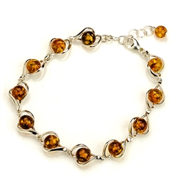 7 round amber beads each set in a sparkling sterling silver frame. 7" to 8" adjustable.