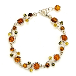 Three colors of amber set in silver shaped to form a colorful trail in this lovely bracelet 8" long.