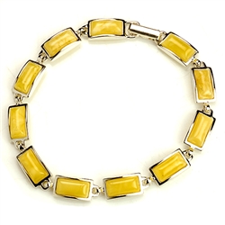 11 rectangular shaped amber beads each set in a sterling silver frame. 7.25" long.