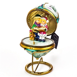 This magnificent ornament is intricately hand painted and accented with genuine Swarovski crystals.  The exquisitely decorated exterior of each ornament portends a story that is completely revealed once the piece is opened. Featured inside each hinged orn