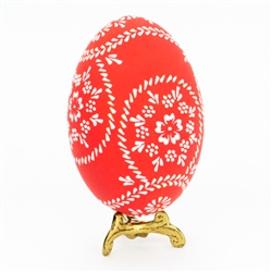 This beautifully designed egg is dyed one color then white wax is melted and applied to form an intricate design which is left on the surface. The egg is emptied. Stand not included.