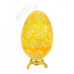 This beautifully designed egg is dyed one color, then white wax is melted and applied to form an intricate design which is left on the surfce. The egg is emptied and strung with ribbon for hanging or you can remove the ribbon.  This is the work of master