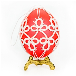 This beautifully designed chicken egg is painted pink and surrounded in a tatted design.
Ready to hang.
