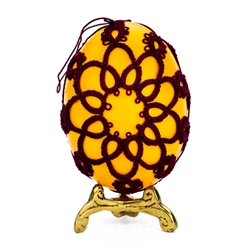 This beautifully designed chicken egg is painted sunflower color and surrounded in a tatted design.
Ready to hang.