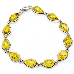 11 tear shaped amber beads each set in a sterling silver frame. 7.5" - 19cm long.