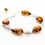 7 spheres of amber each set with sparkling sterling. 7" to 8" adjustable.