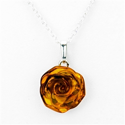 Beautiful amber rose pendant on an adjustable length silver chain,  Amber rose is approx .5" diameter. x .25" wide. Sterling silver back.
