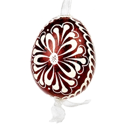 This beautifully designed quail egg is dyed one color, then white wax is melted and applied to form an intricate design which is left on the surface. Please note that quail eggs shells are naturally speckled brown and black and the black surfaces remain