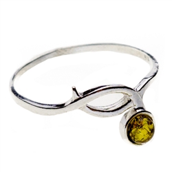 Petite size green oval amber set in sterling silver.