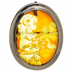 Beautiful oval shaped sterling silver amber cameo pendant/brooch. Can be worn either as a pendant using the silver loop or as a brooch using the pin. The cameo is hand carved from the back of the pendant. Nicely detailed. Size is approx 1.5" x 1.25".