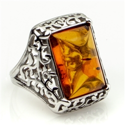 Honey colored amber and sterling silver filigree ring. Size approx. .5" x .75".