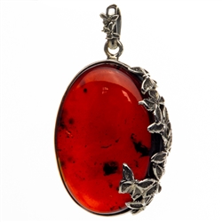Beautiful cherry amber cabochon framed in antique style sterling silver.  Please note that this picture was taken with background light to highlight the interior.  Actual appearance is dark cherry. Size is approx 2.25" x 1.25" x .5".