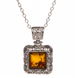 Sterling Silver with antique detail surrounding a beautiful honey amber cabochon.   Pendant is 1" x .75".