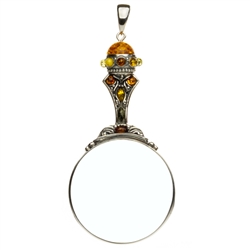 Unique and beautifully hand-crafted sterling silver magnifying glass decorated with amber highlights.  Has its own silver finding which can be used to attach a chain if desired. Size is approx 4.25" x 2".
