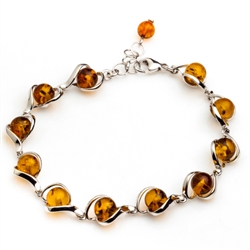 11 round amber beads each framed in sterling silver. 8.5" - 22cm long.